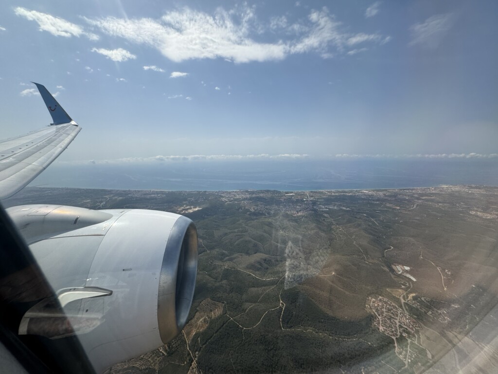 an airplane wing and a landscape