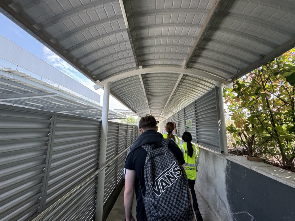 a group of people walking under a covered walkway